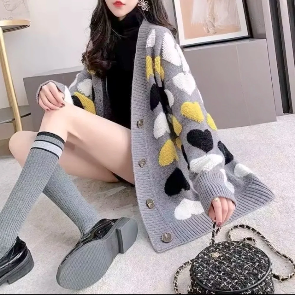 Gray button up cardigan sweater with plush heart pattern